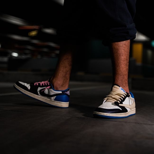 Fashion-forward sneakers captured on a man's feet in a dimly lit setting, showcasing streetwear style. — Ali Dashti, Pexels