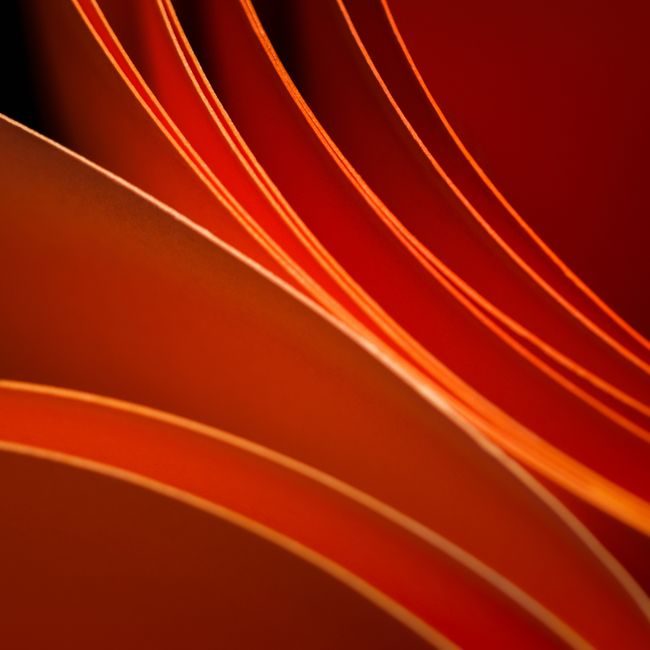 Abstract image showcasing elegant waves of red and orange paper, creating a minimal and modern design. — Jakub Zerdzicki, Pexels
