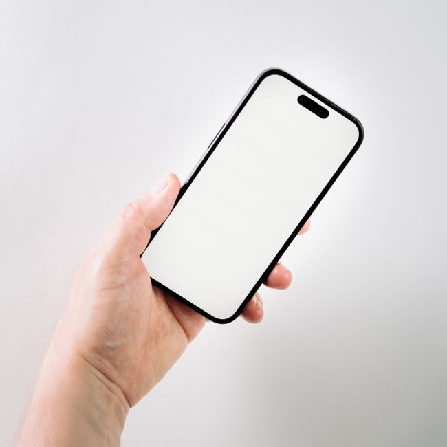 A hand holding a smartphone with a blank screen, ideal for app mockups and presentations. — Jakub Zerdzicki, Pexels
