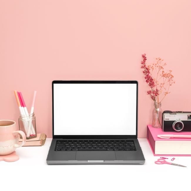Stylish pink-themed workspace featuring a laptop, vintage camera, and stationery on a tidy desk. — Jilly Noble, Pexels