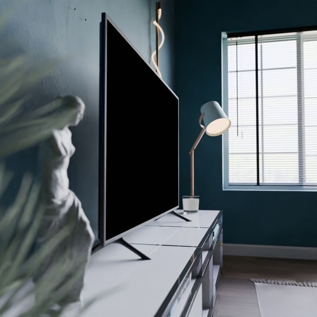 A stylish modern room featuring a statue, flat screen TV, and window light. — Pușcaș Adryan, Pexels