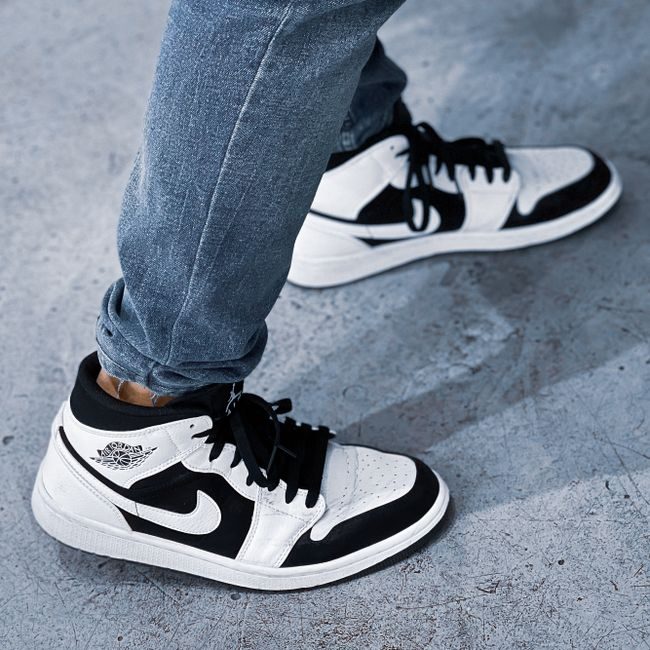 Close-up of black and white Nike sneakers worn in an urban setting in Kuwait. — Abdullah Alsaibaie, Pexels
