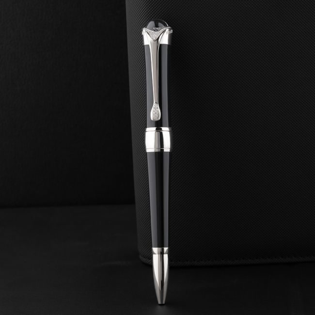 Sleek black pen with silver accents on a textured black surface, exuding elegance and luxury. — The Glorious  Studio, Pexels