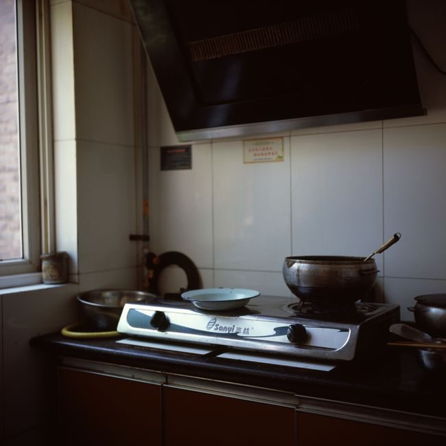A small kitchen stove with pots and pans in a cozy interior setting, ideal for domestic and home themes. — Zechen Li, Pexels