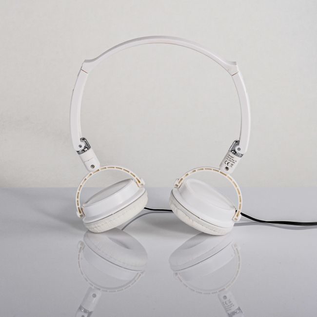 Close-up of stylish white headphones on a reflective neutral surface. — Saeed Khokhar, Pexels