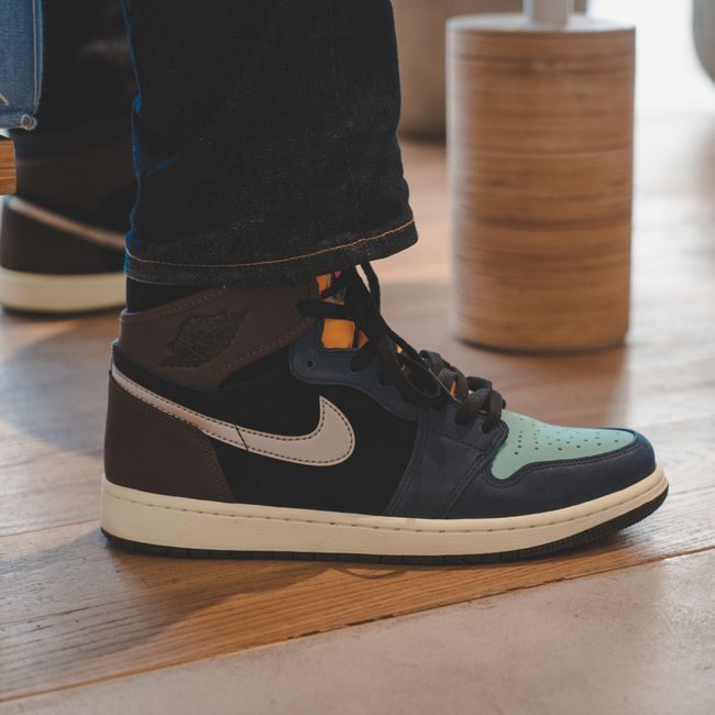 Close-up of fashionable Air Jordan sneakers on a wooden floor, capturing a trendy urban look. — Abdullah Alsaibaie, Pexels