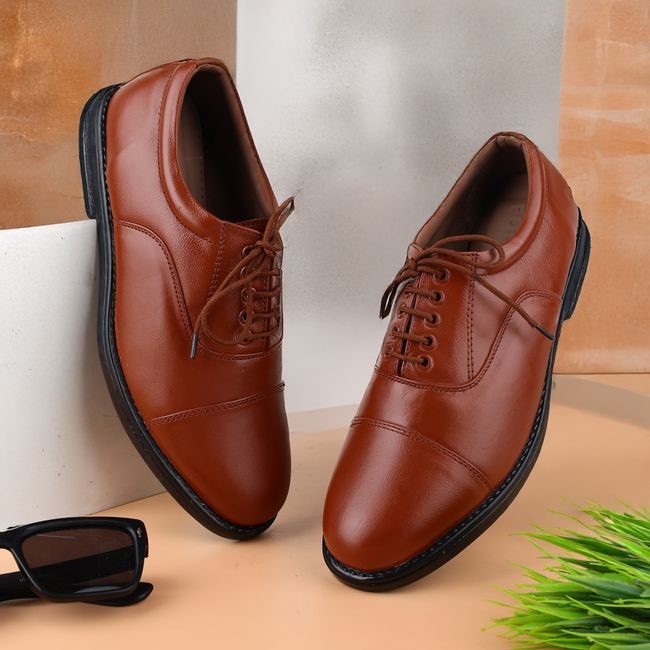 Elegant tan leather shoes paired with sunglasses, perfect for modern fashion enthusiasts. — ALOK DAS, Pexels
