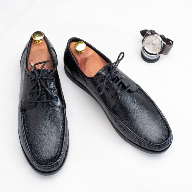 Stylish black leather shoes paired with a classic wristwatch on a white surface. — Rujwal Pradhan, Pexels