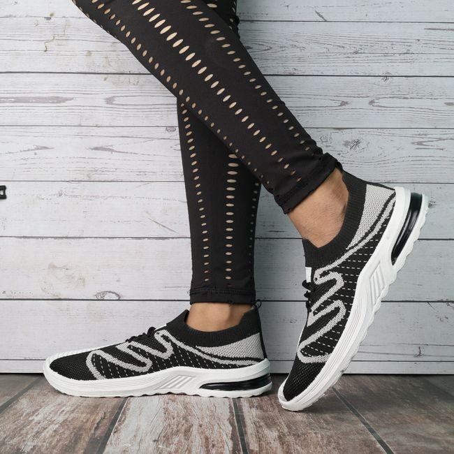 Fashionable black and white sneakers paired with trendy leggings, ideal for casual outings. — ALOK DAS, Pexels