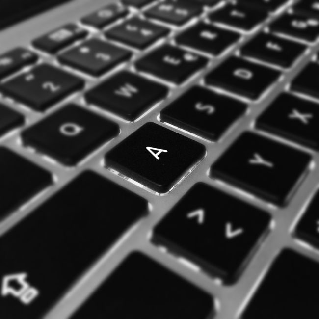 Artistic black and white close-up of a laptop keyboard focusing on the letter 'A'. — Image Hunter, Pexels
