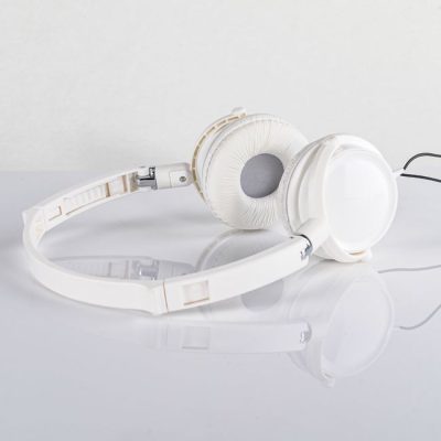 Close-up of white headphones on a reflective white surface, showcasing modern design. — Saeed Khokhar, Pexels