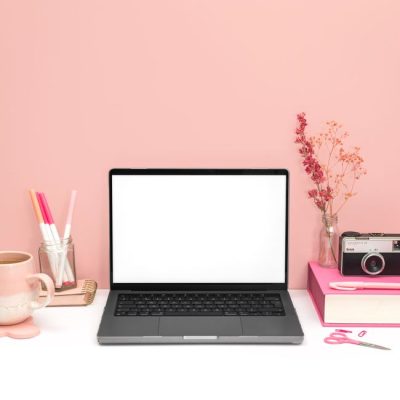 Stylish pink-themed workspace featuring a laptop, vintage camera, and stationery on a tidy desk. — Jilly Noble, Pexels