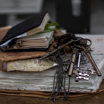 Aesthetic still life of vintage journals and antique keys on layered paper, evoking a sense of history and nostalgia. — Danyale R Zink, Pexels