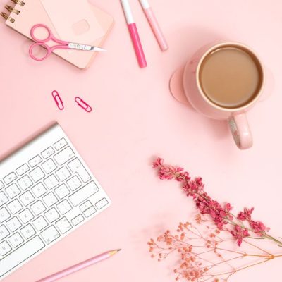 Aesthetic flat lay of a pink desk featuring stationery, coffee, and flowers for a modern workspace vibe. — Jilly Noble, Pexels
