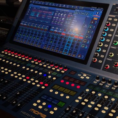 A close-up of a professional audio mixing console featuring a digital touchscreen interface with multiple control knobs. — 폭 폭, Pexels
