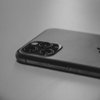 Black and white close-up of a modern smartphone camera highlighting its sleek design. — Amar  Preciado, Pexels
