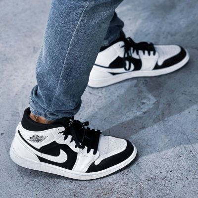 Close-up of black and white Nike sneakers worn in an urban setting in Kuwait. — Abdullah Alsaibaie, Pexels