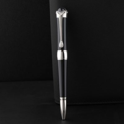 Sleek black pen with silver accents on a textured black surface, exuding elegance and luxury. — The Glorious  Studio, Pexels