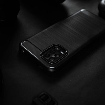Close-up of a sleek black smartphone on a dark surface, highlighting elegant design. — Carlos Jairo, Pexels