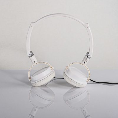 Close-up of stylish white headphones on a reflective neutral surface. — Saeed Khokhar, Pexels