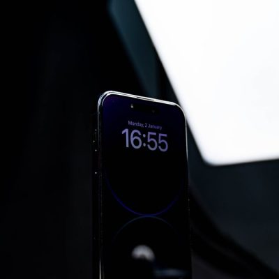 Close-up of a smartphone displaying time against a dark backdrop, highlighting screen technology. — Kafeel Ahmed, Pexels