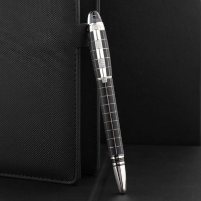 Close-up of a stylish pen held by a textured notebook against a sleek black background, ideal for corporate imagery. — The Glorious  Studio, Pexels
