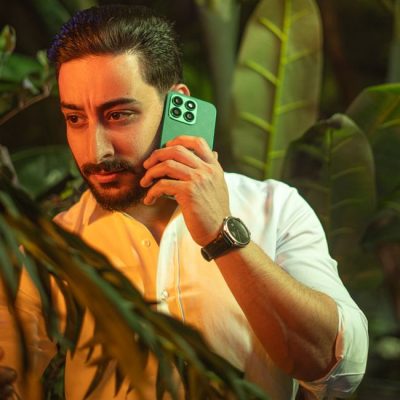 A man using a smartphone in a vibrant jungle setting, conveying a blend of nature and technology. — khezez  | خزاز, Pexels