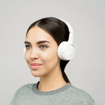 Smiling woman enjoying music with white headphones indoors, modern lifestyle portrait. — Sound On, Pexels