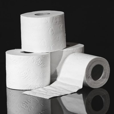 High-quality close-up image of stacked toilet paper rolls against a black background. — Alexas Fotos, Pexels
